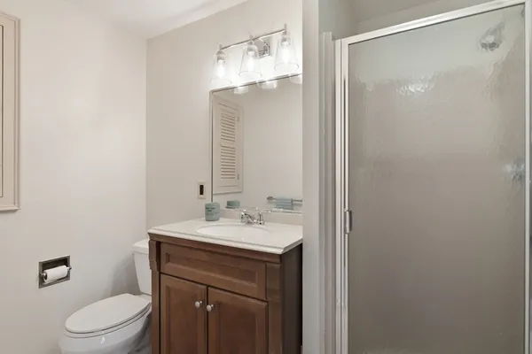 a bathroom with a sink a toilet and shower