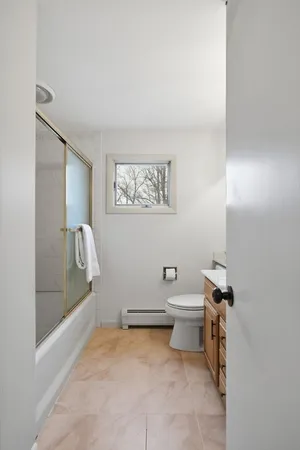 a bathroom with a toilet and a shower