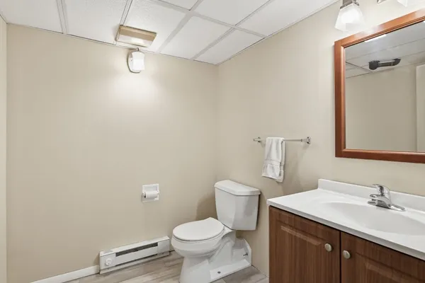 a bathroom with a sink a toilet and a mirror