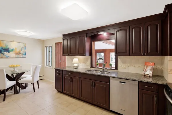 a kitchen with granite countertop a sink cabinets and window