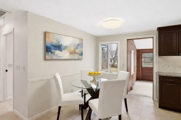 a view of a dining room with furniture and a window