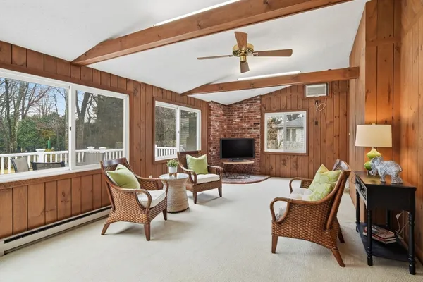 a living room with furniture and a floor to ceiling window