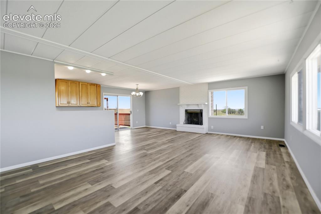 19027 Murphy Road Peyton, CO 80831 - Photo 5 of 48 Vinyl Plank, Fireplace, Sliding Door To Deck