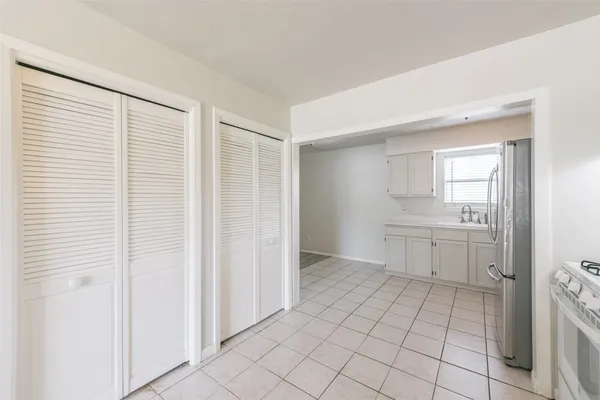 a view of a kitchen with white cabinets