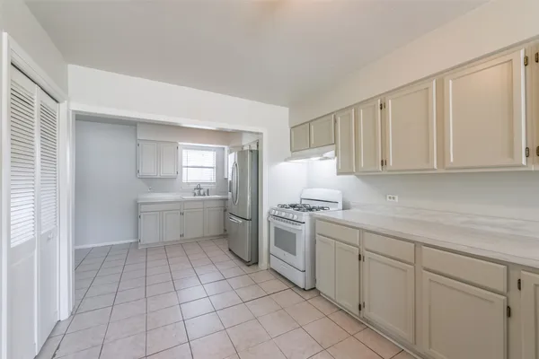 a kitchen with a sink window and cabinets