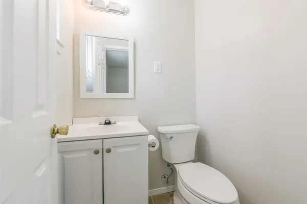 a white toilet sitting next to a white sink