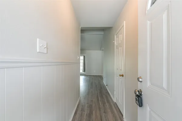 a view of a room with wooden floor