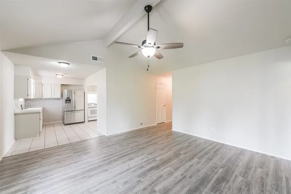 a view of a kitchen with wooden floor and a kitchen