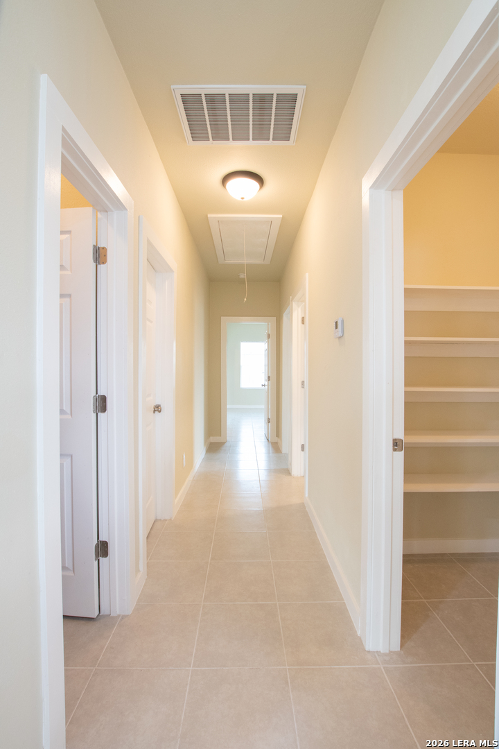 2621 Pahmeyer Road New Braunfels, TX 78130 - Photo 18 of 28 a view of a hallway with wooden floor and a bathroom