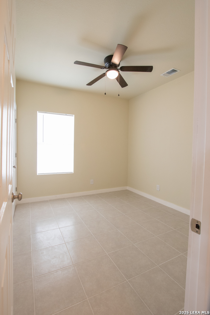 2621 Pahmeyer Road New Braunfels, TX 78130 - Photo 19 of 28 an empty room with a window and a fan