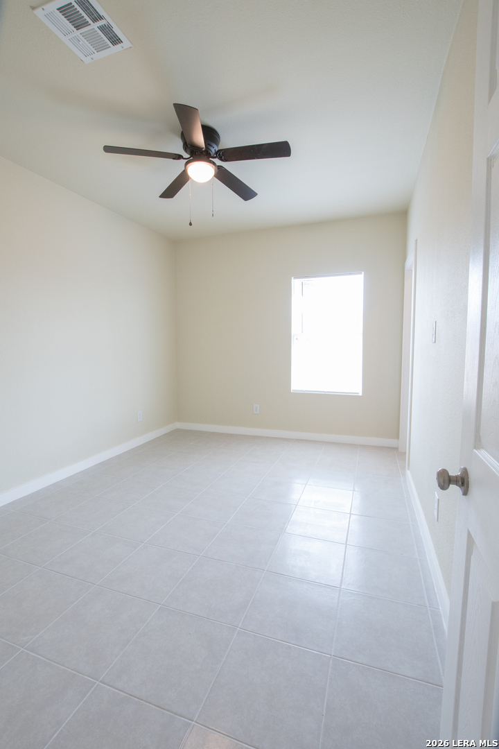 2621 Pahmeyer Road New Braunfels, TX 78130 - Photo 22 of 28 an empty room with a window and a fan