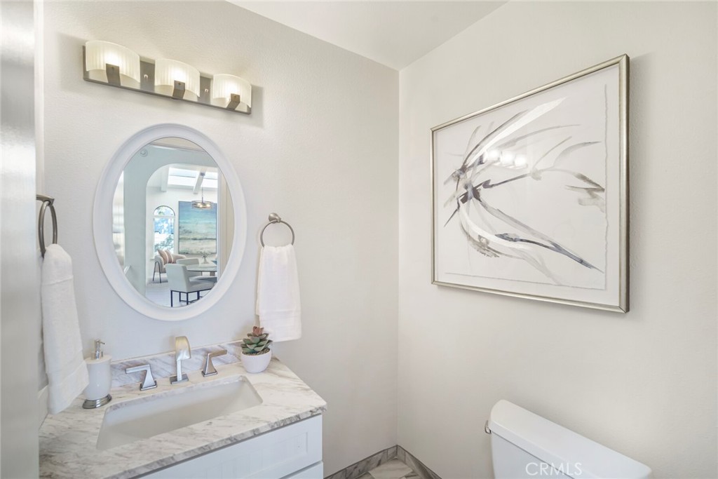 32321 Azores Road Dana Point, CA 92629 - Photo 11 of 46 a bathroom with a granite countertop sink mirror and vanity