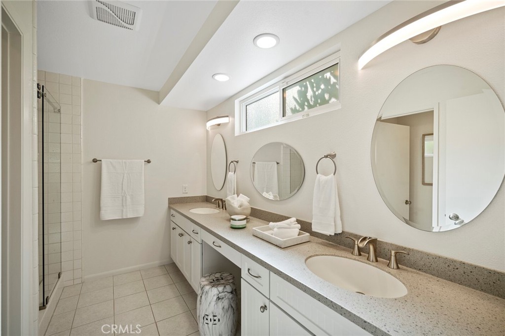 32321 Azores Road Dana Point, CA 92629 - Photo 17 of 46 a bathroom with a double vanity sink mirror and shower