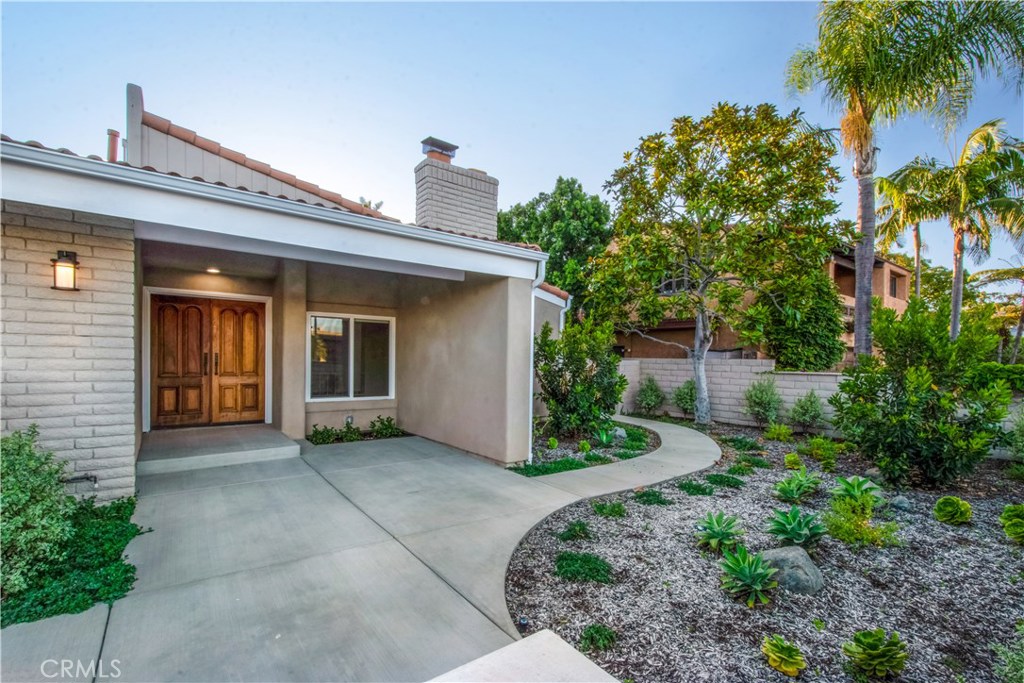32321 Azores Road Dana Point, CA 92629 - Photo 2 of 46 a view of a house with potted plants and a large tree