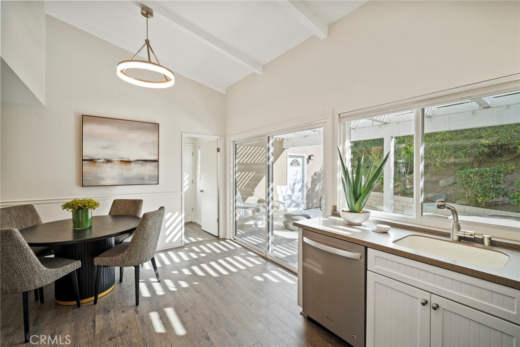 32321 Azores Road Dana Point, CA 92629 - Photo 22 of 46 a dining hall with stainless steel appliances granite countertop a dining table chairs and couches next to a window