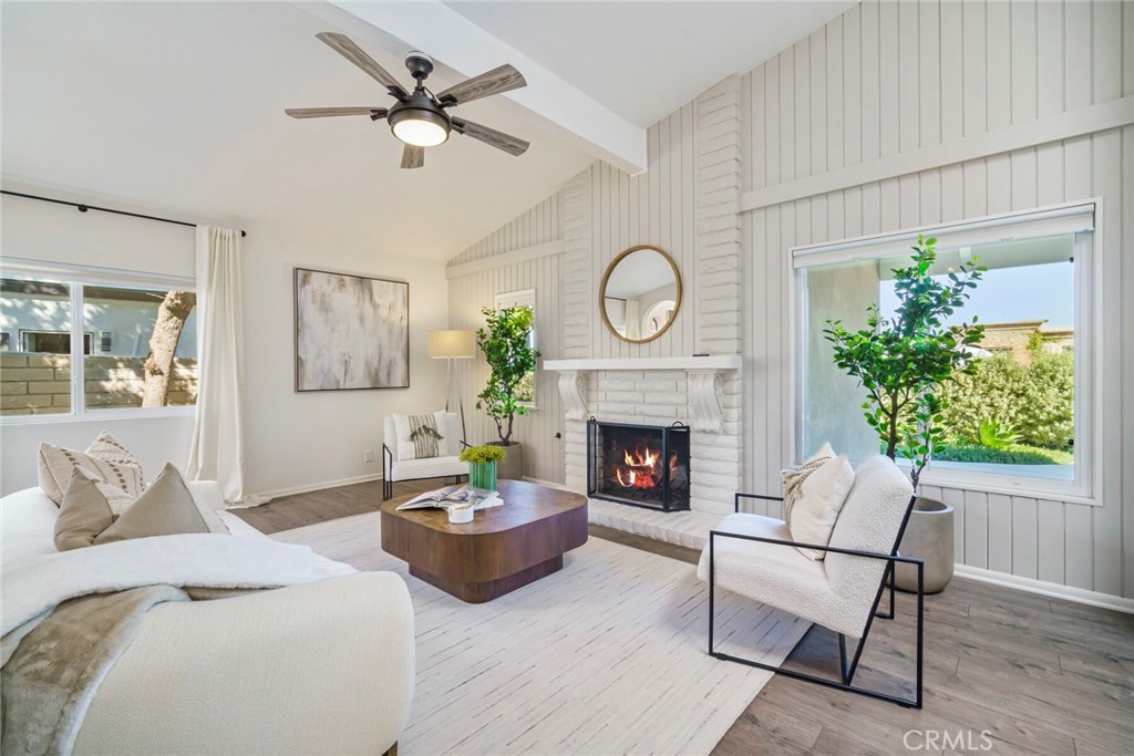 32321 Azores Road Dana Point, CA 92629 - Photo 4 of 46 a living room with furniture a clock and a fireplace