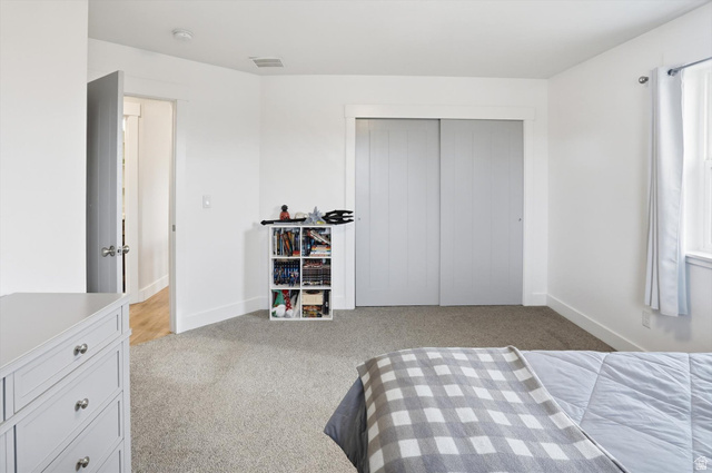 1009 High Creek Road Cove, UT 84320 - Photo 41 of 79 Bedroom with light carpet and a closet