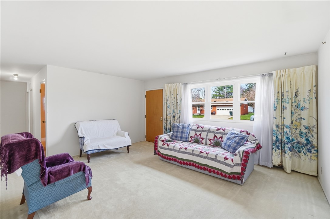 1087 Fairfield Road Troy, OH 45373 - Photo 5 of 39 This bright living space features soft carpeting and ample natural light from large windows.