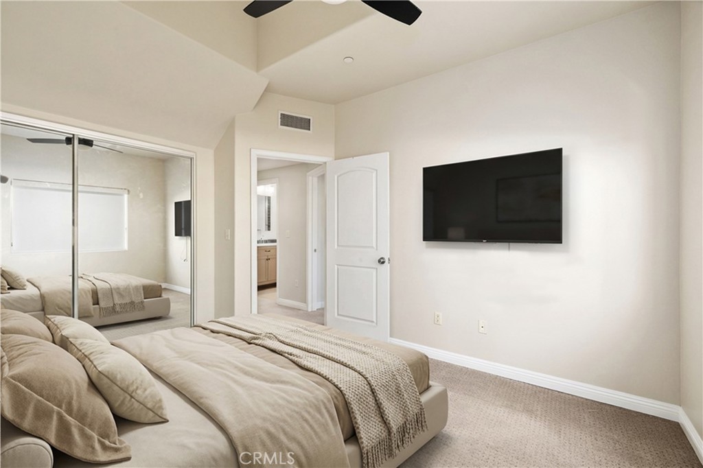 14535 Margate Street, Unit 13 Sherman Oaks, CA 91411 - Photo 12 of 22 a bedroom with a bed and a flat screen tv