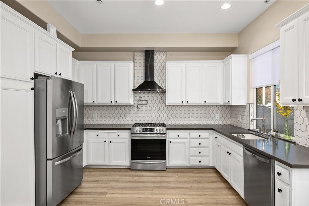 14535 Margate Street, Unit 13 Sherman Oaks, CA 91411 - Photo 4 of 22 a kitchen with stainless steel appliances granite countertop a stove a refrigerator and a sink