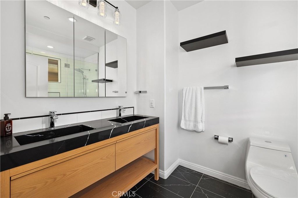 14535 Margate Street, Unit 13 Sherman Oaks, CA 91411 - Photo 10 of 22 a bathroom with a sink a toilet and a mirror