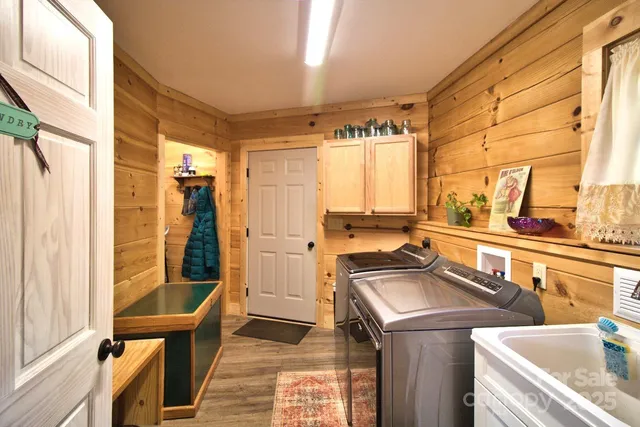 a kitchen that has a sink a chair and glass door