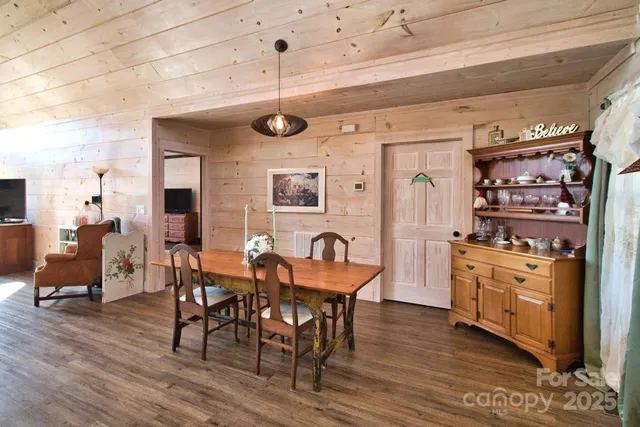 a dining room with furniture and wooden floor