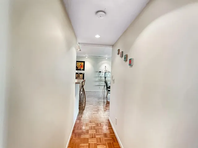 a view of a dining room with furniture and a potted plant