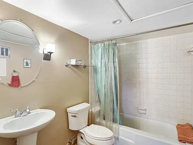 a living room with furniture a flat screen tv and a window