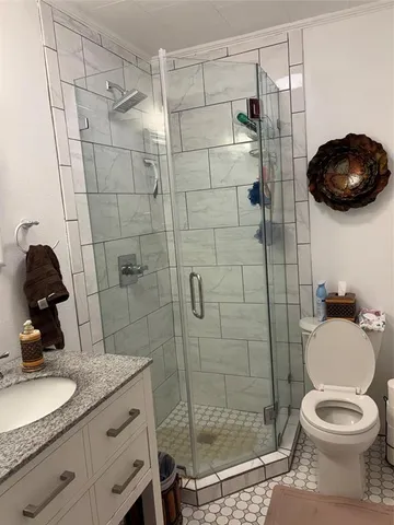 a bathroom with a toilet and a shower