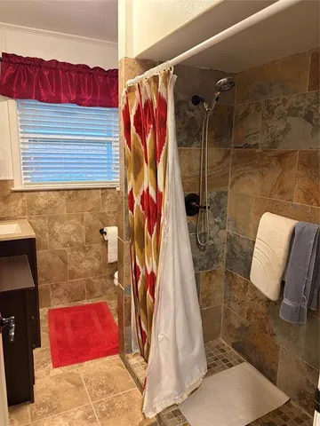 a bathroom with a shower and a sink