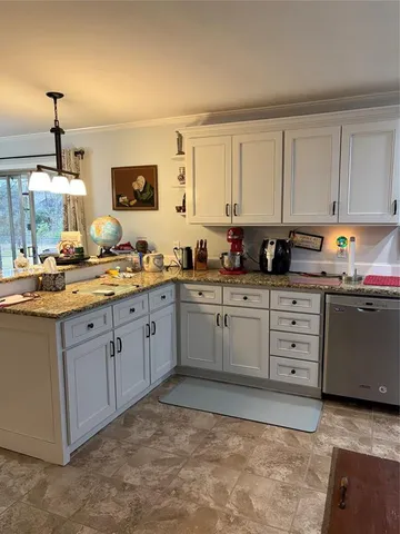 a kitchen with white cabinets and white appliances