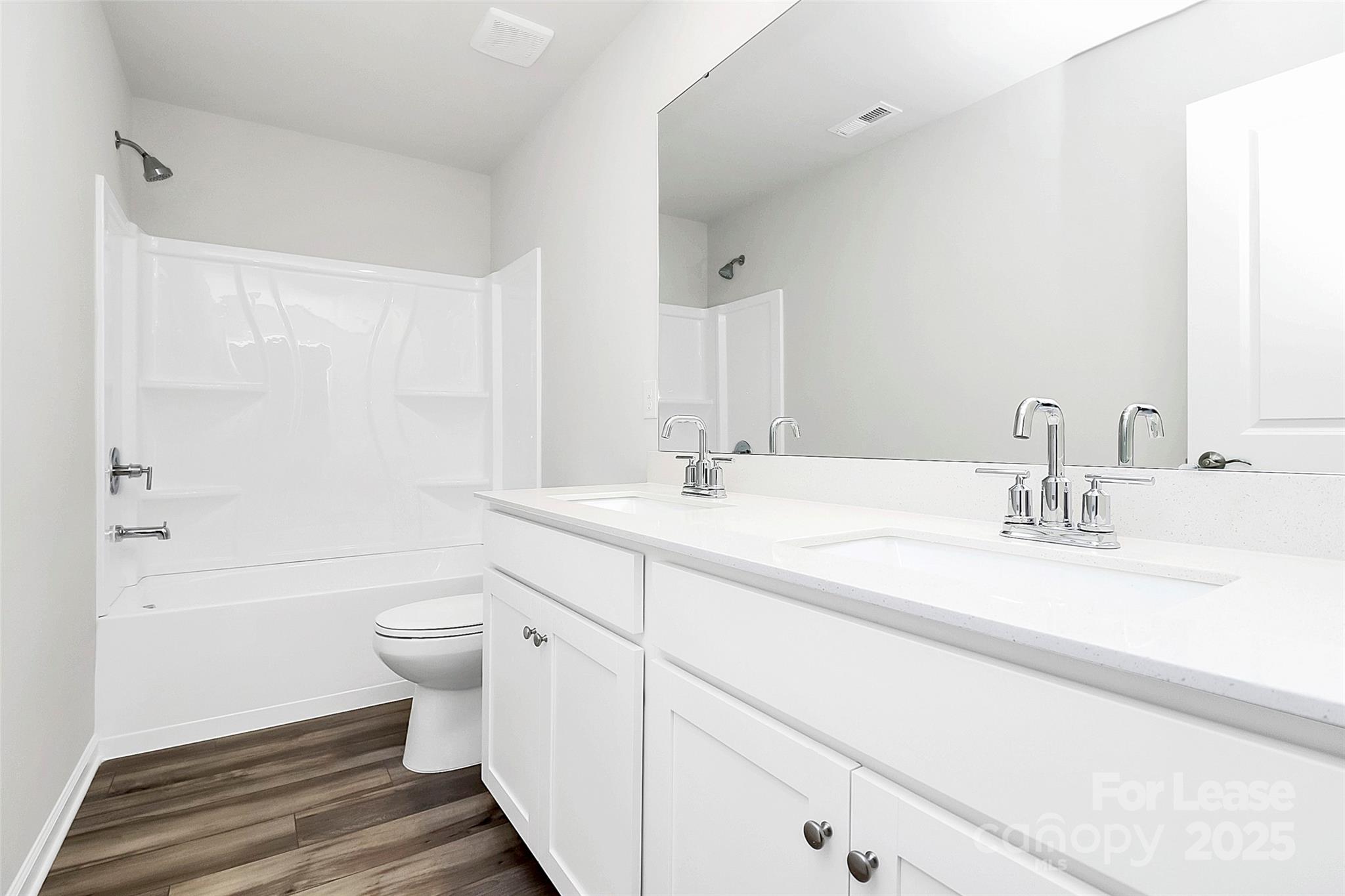 1617 Swallow Tail Drive Belmont, NC 28012 - Photo 11 of 18 a bathroom with a double vanity sink toilet and shower