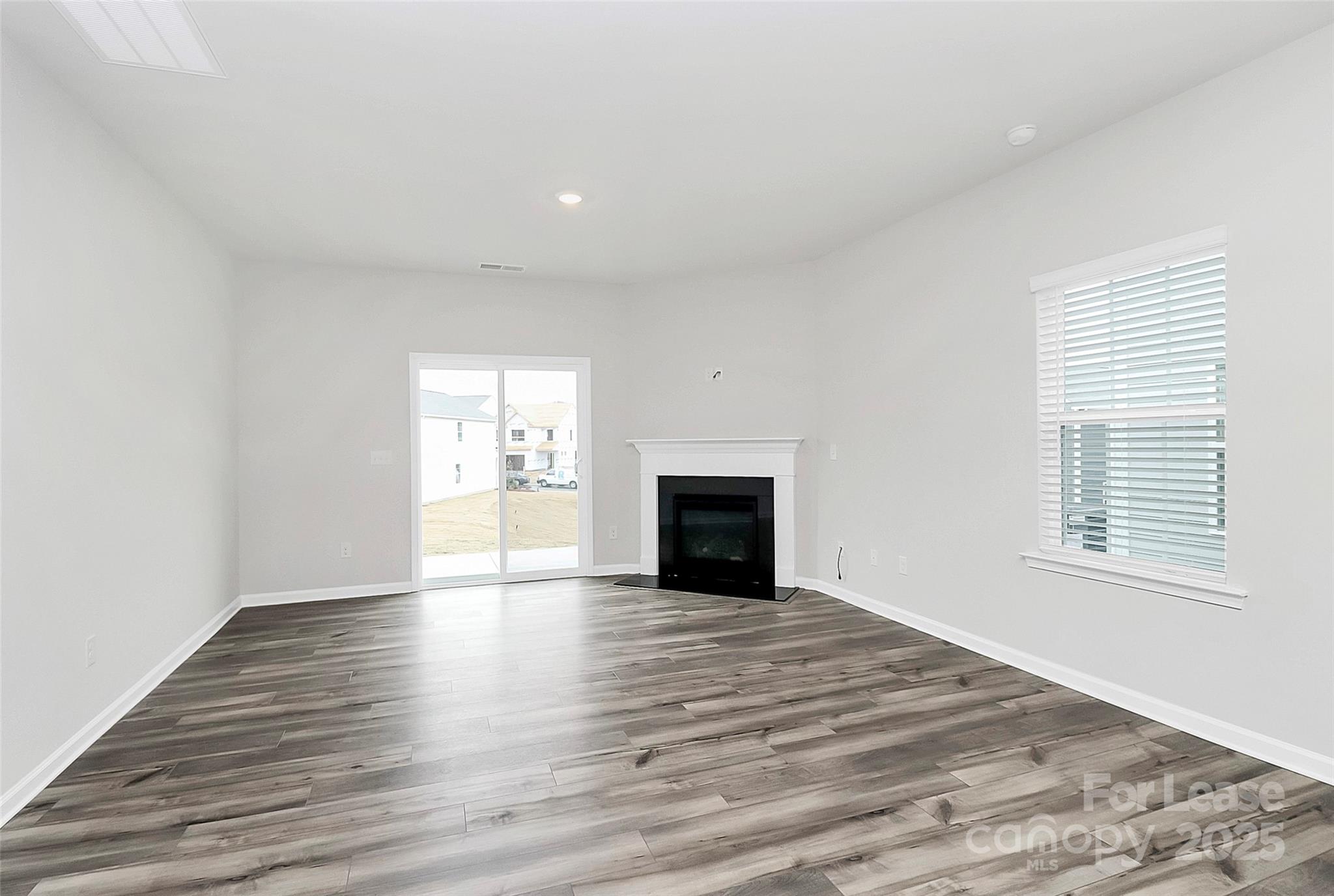 1617 Swallow Tail Drive Belmont, NC 28012 - Photo 4 of 18 a view of an empty room with wooden floor and a window