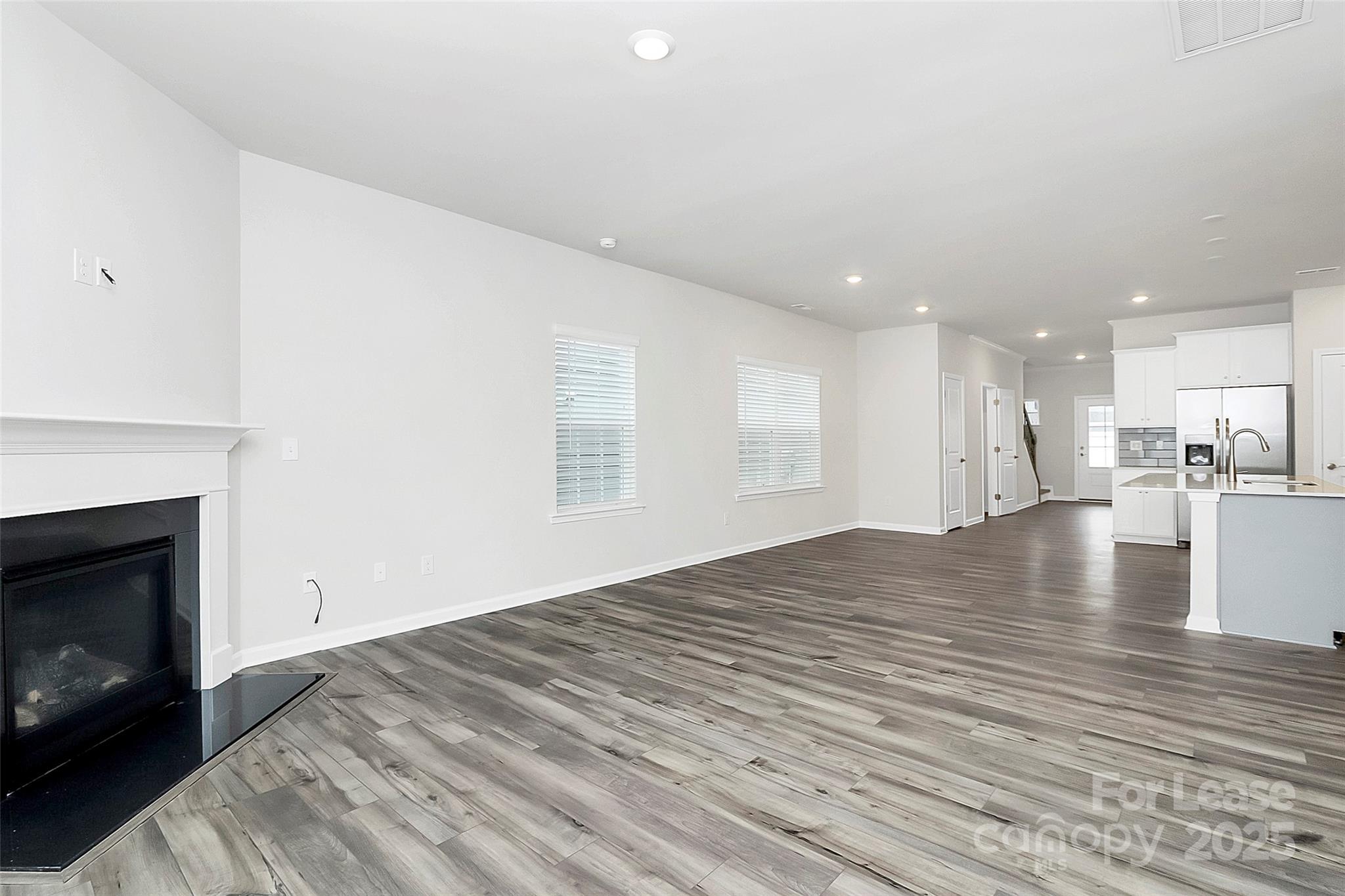 1617 Swallow Tail Drive Belmont, NC 28012 - Photo 5 of 18 a view of empty room with kitchen and fireplace