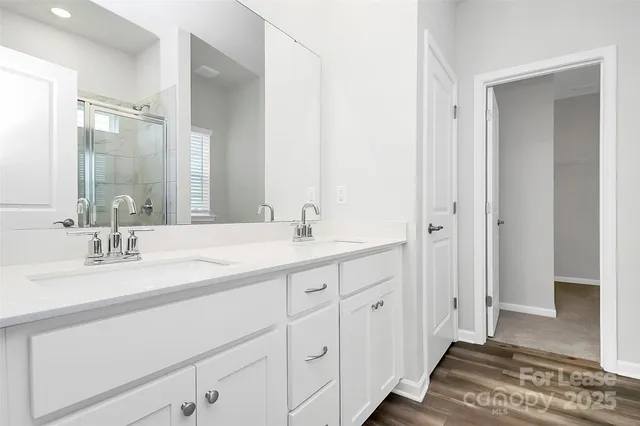 a bathroom with a double vanity sink and a mirror