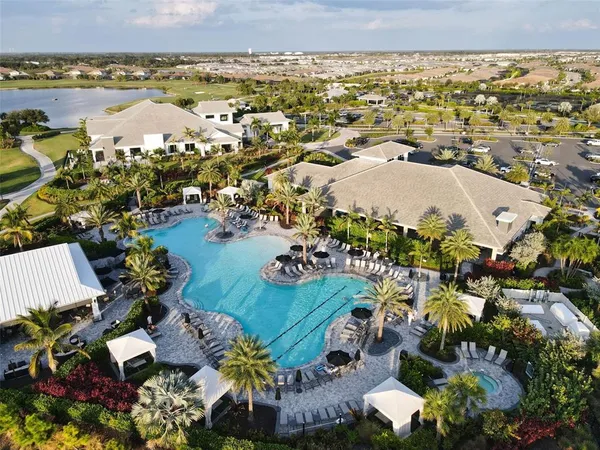 a spacious bathroom with a double vanity sink a large mirror and a shower