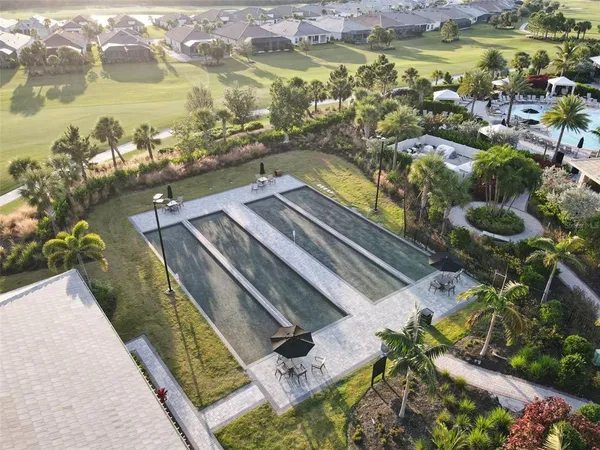 a living room with patio furniture and a floor to ceiling window