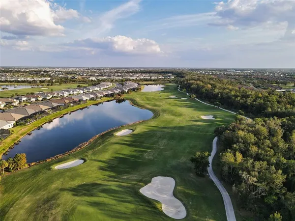 a large kitchen with stainless steel appliances kitchen island granite countertop a lot of counter space and a sink