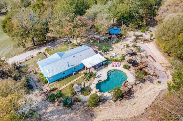 a view of backyard with large trees