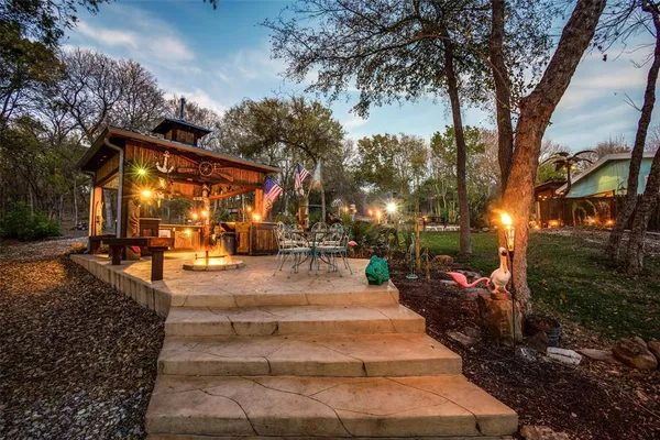 an aerial view of a house with swimming pool patio and outdoor seating