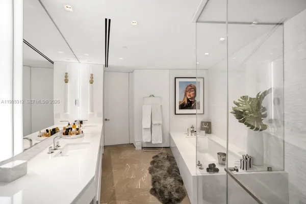 a bath room with a sink tub and view of living room