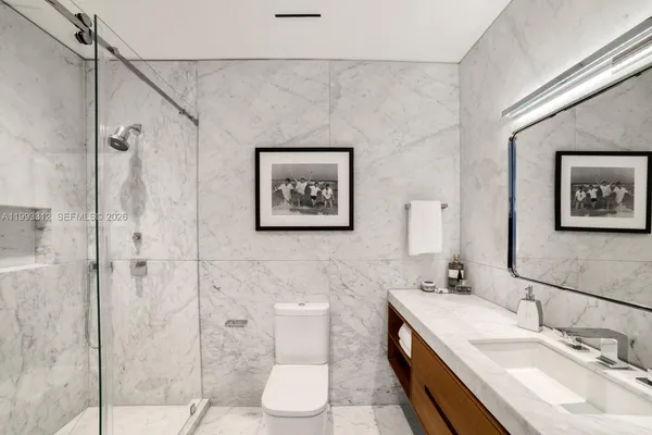 a bathroom with a double vanity sink toilet and shower