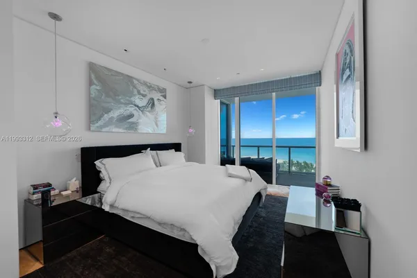 a bedroom with a bed and a large window