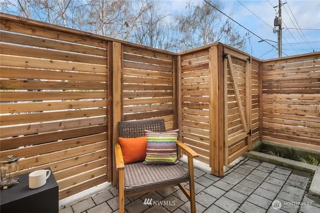 a view of a balcony with a chair and the iron stairs