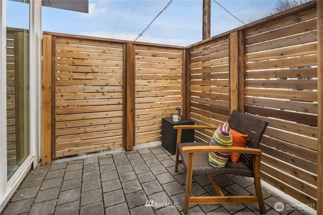 a view of a patio with a table and chairs and wooden floor