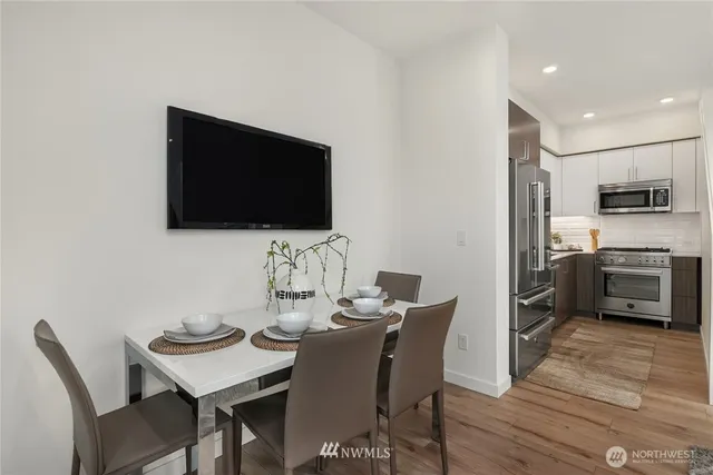 a view of a dining room with furniture and wooden floor