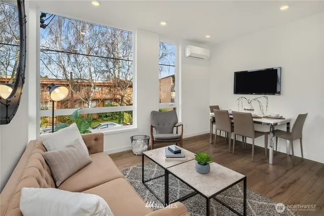 a living room with furniture wooden floor and a flat screen tv