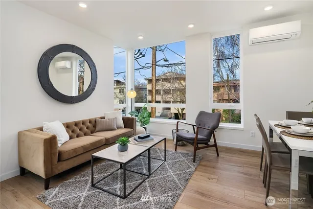 a living room with furniture a large window and a table