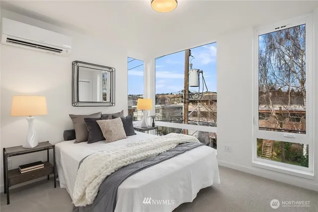 a bedroom with beds and a window